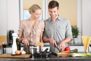 couple cooking food together